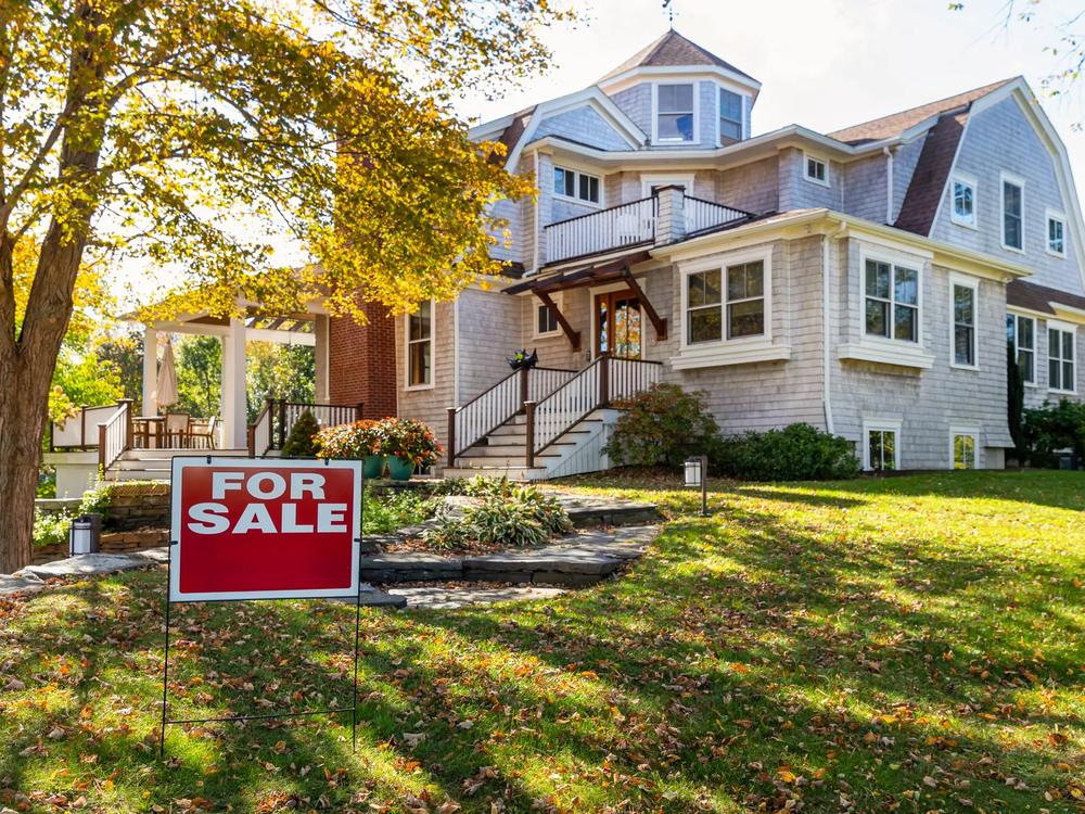 A Home For Sale sign in a front yard